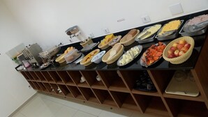 A buffet setup with various food items and utensils. - Estrela da Água Fria (São Paulo)
