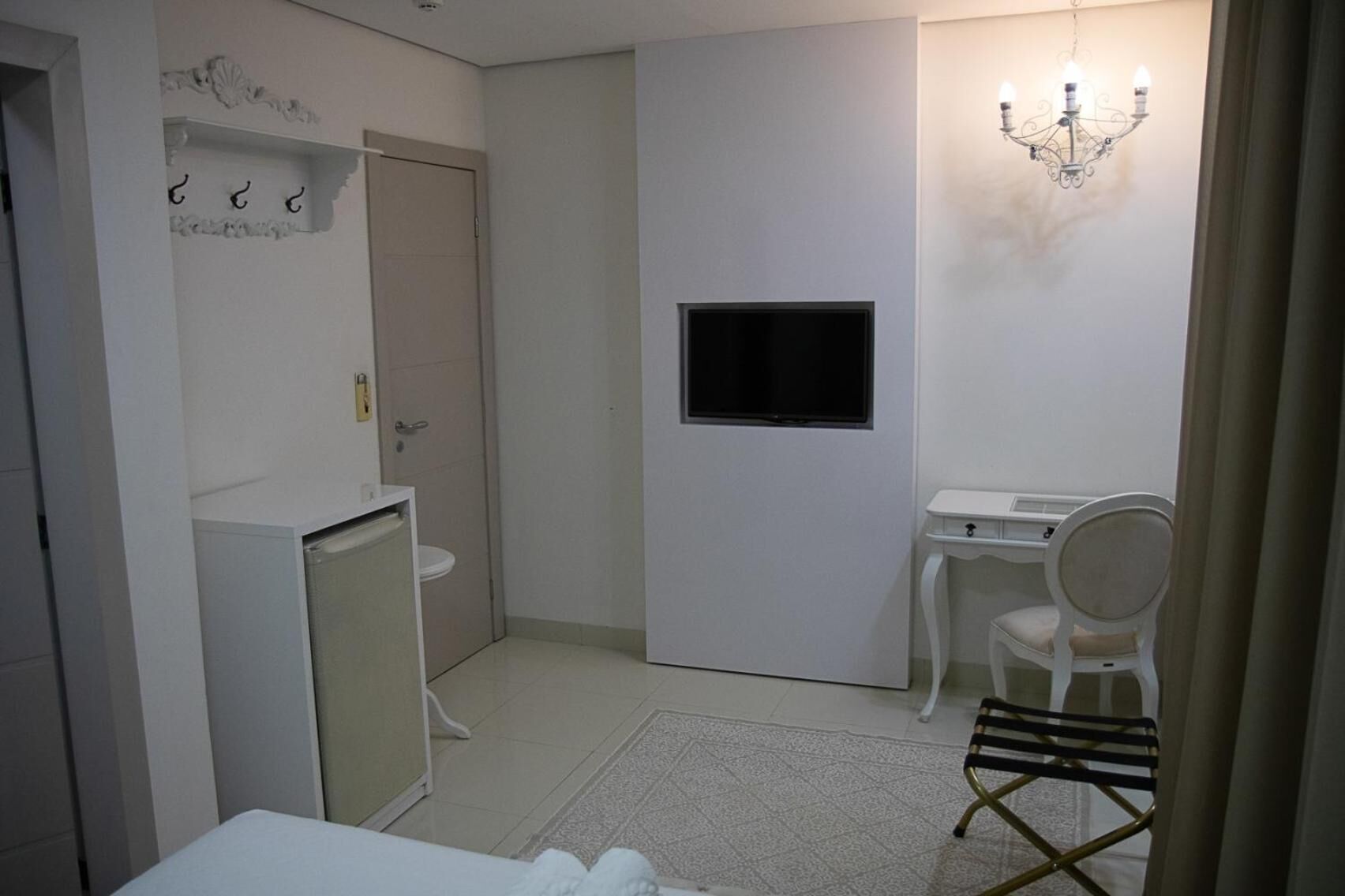 A compact bathroom with a toilet, sink, and a small cabinet.