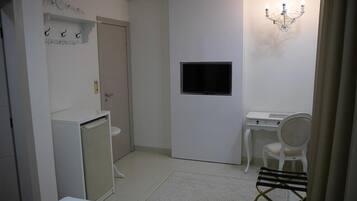 A compact bathroom with a toilet, sink, and a small cabinet.