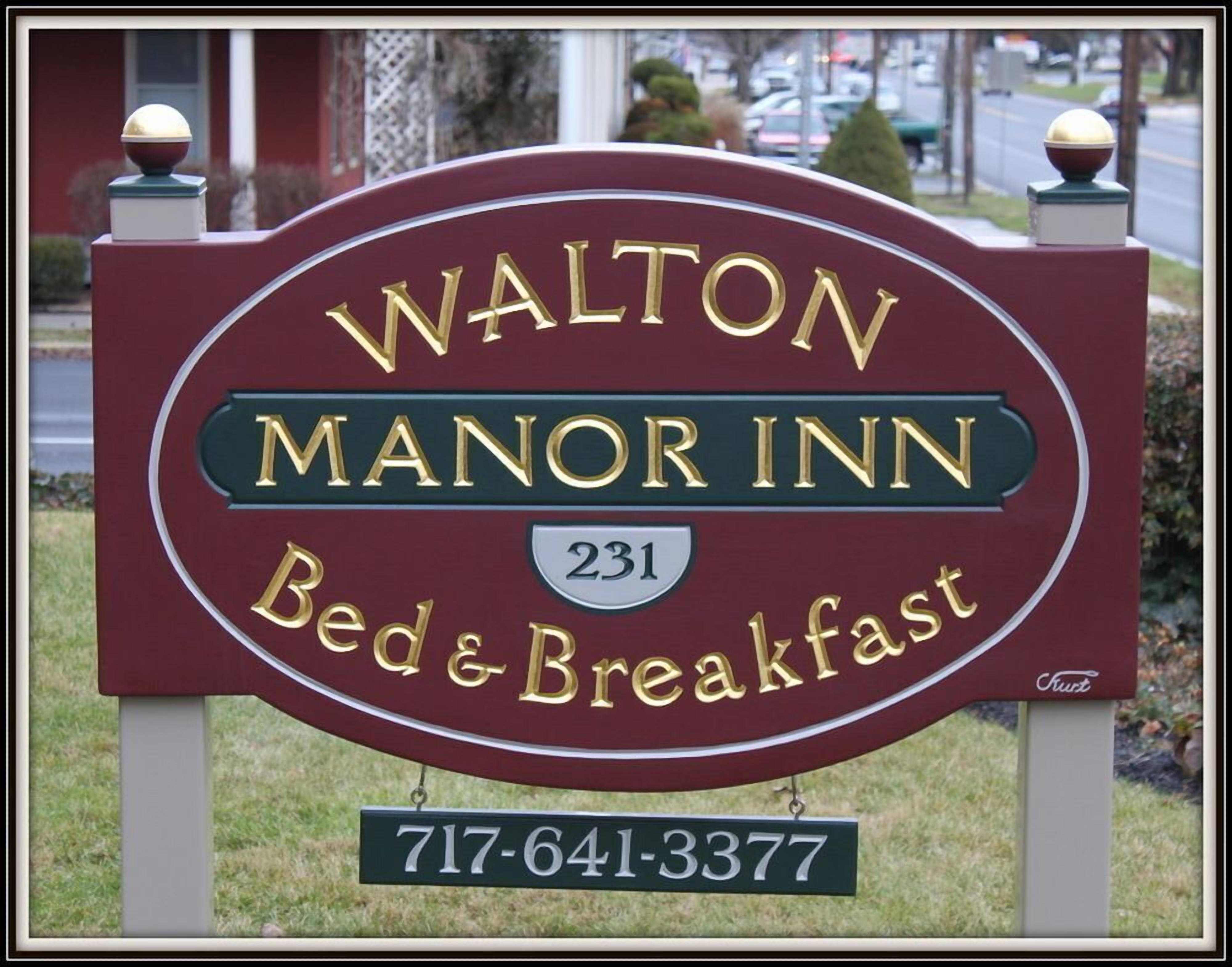 A sign for Walton Manor Inn, indicating it offers bed and breakfast services.