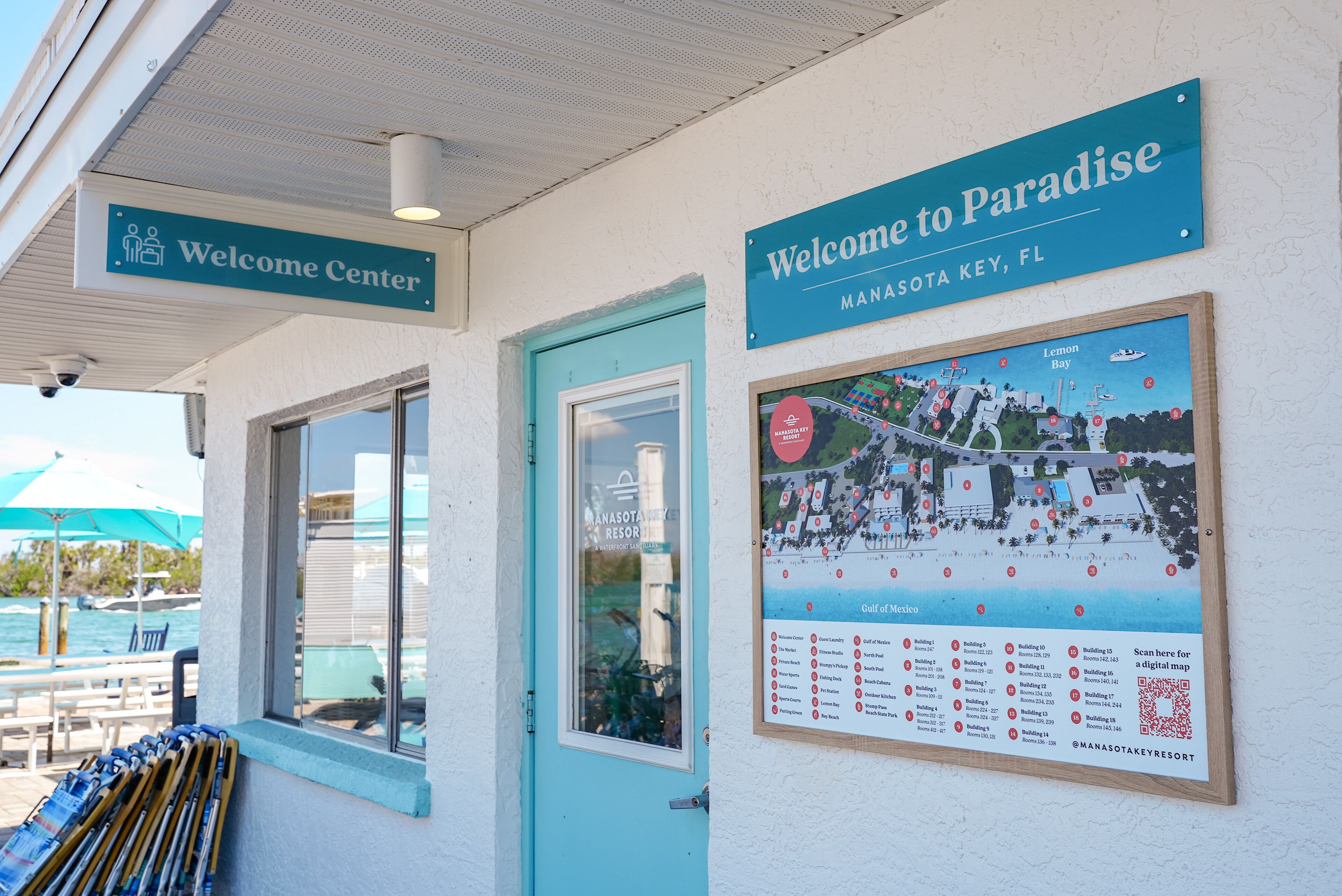 A welcome center with a sign reading "Welcome to Paradise" and a map of the resort.