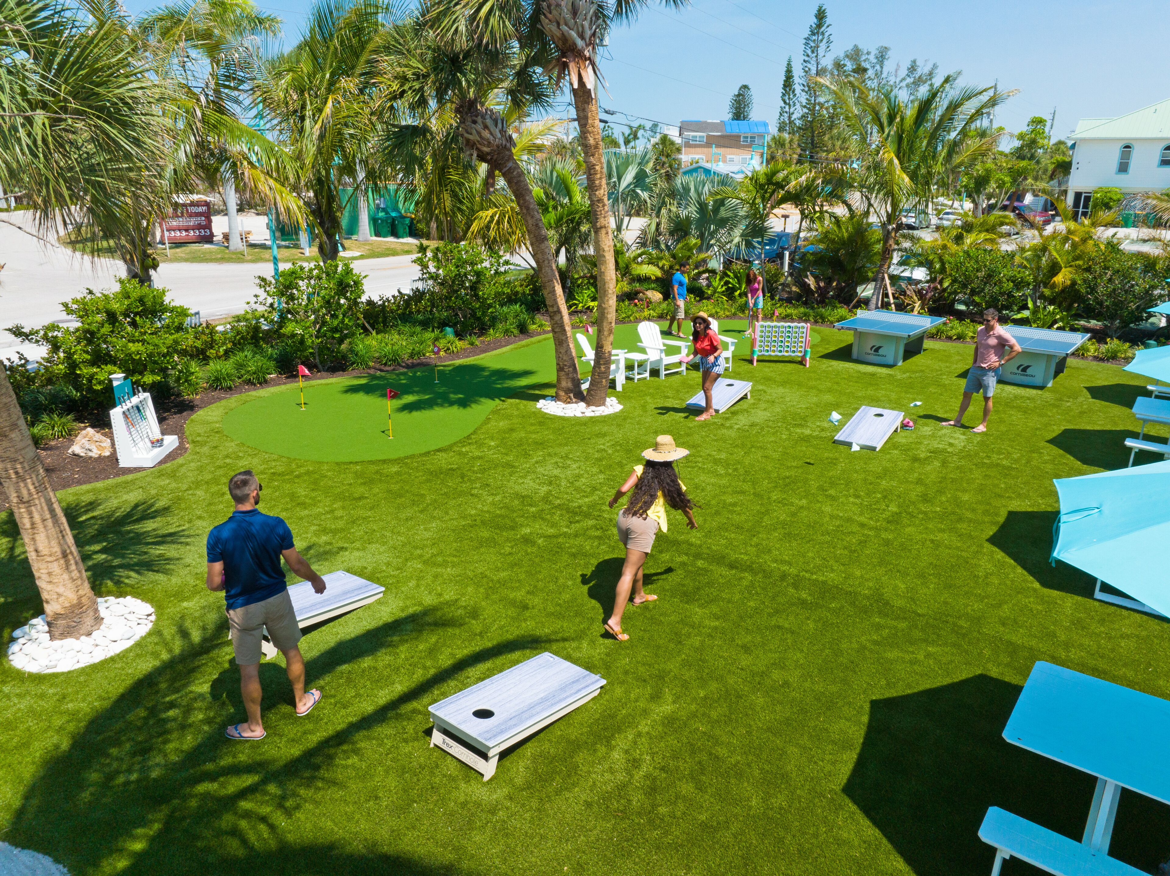 A well-maintained lawn with outdoor seating and a pool area.