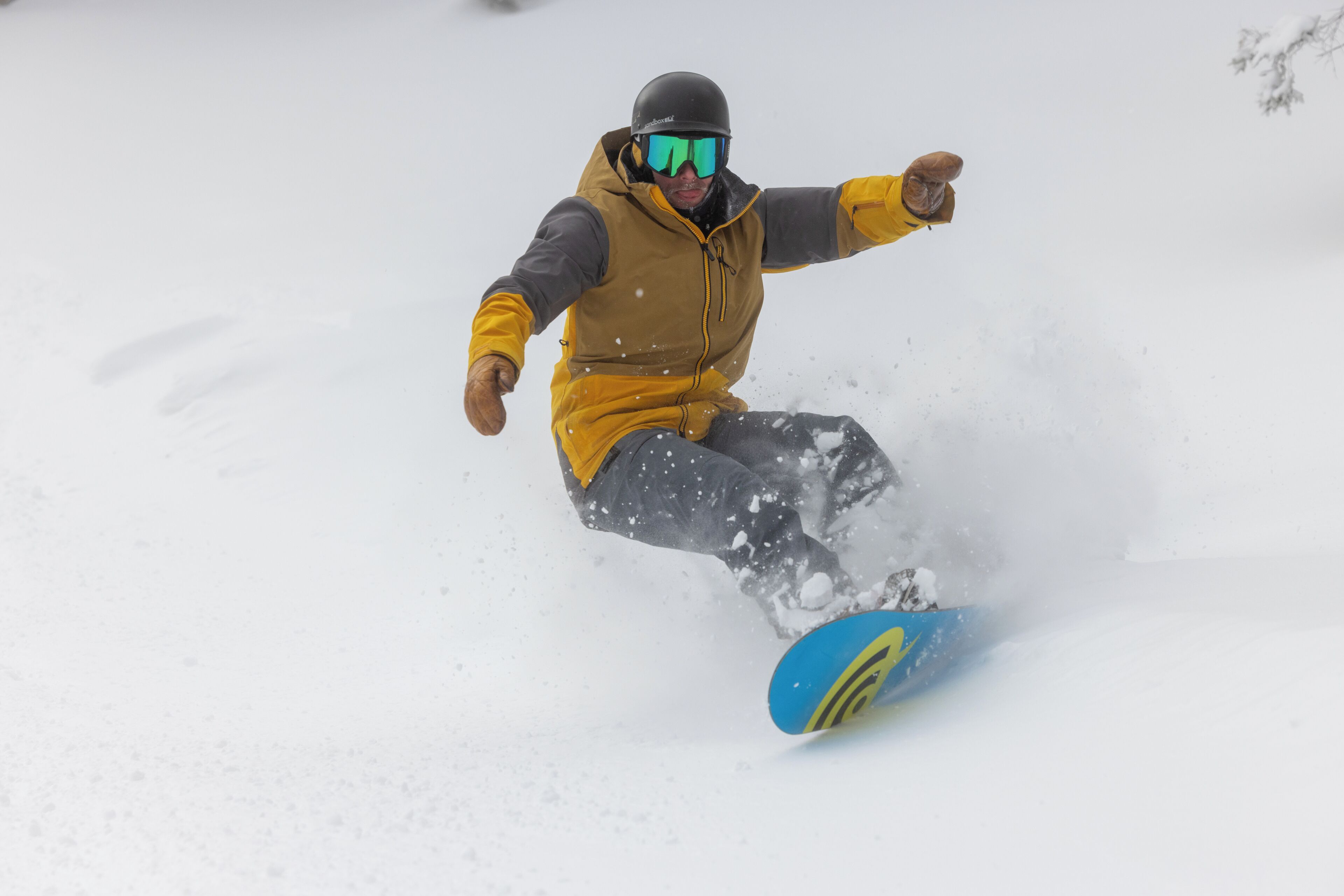 A snowboarder in motion on a snowy slope.