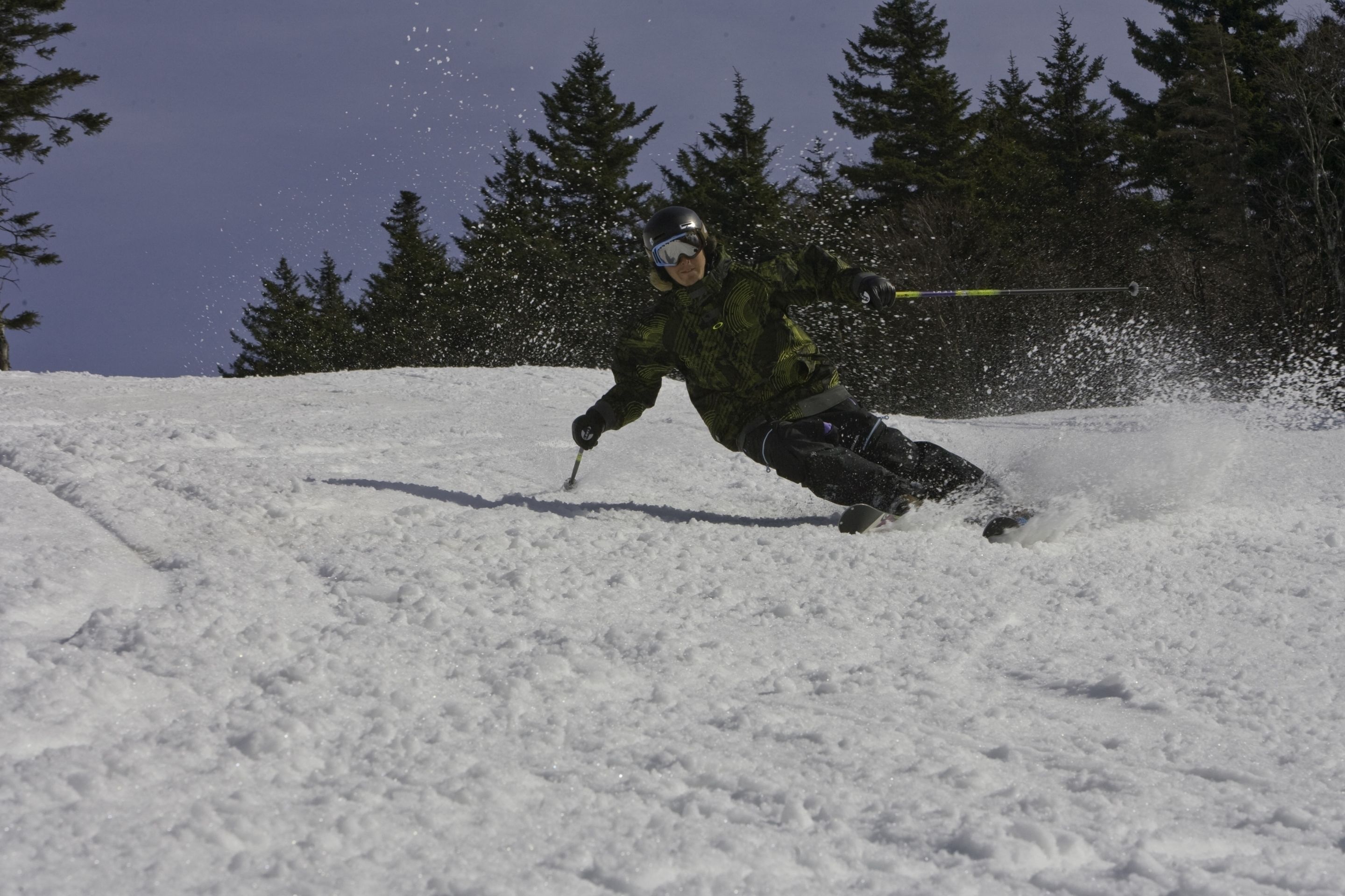 A person skiing down a snowy slope.