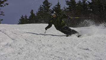A person skiing down a snowy slope.