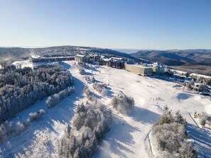 A ski resort with multiple buildings, including lodges and a ski lift area. - The Inn at Snowshoe (Snowshoe)