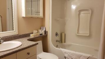A bathroom with a sink, toilet, and bathtub.