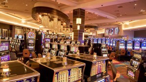 A casino with multiple slot machines and a bar area. - Courtyard by Marriott Evansville East (Evansville)