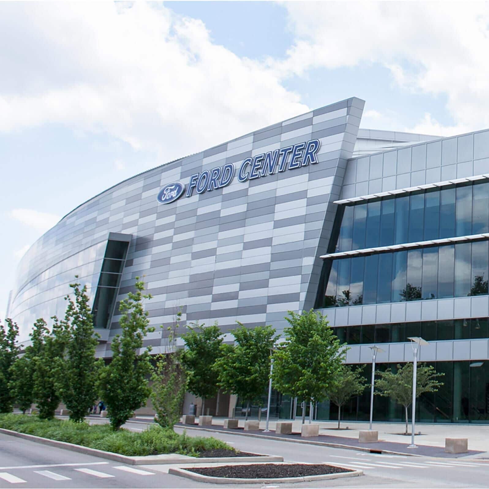 A modern building with a curved facade and the text "FORD CENTER" prominently displayed.