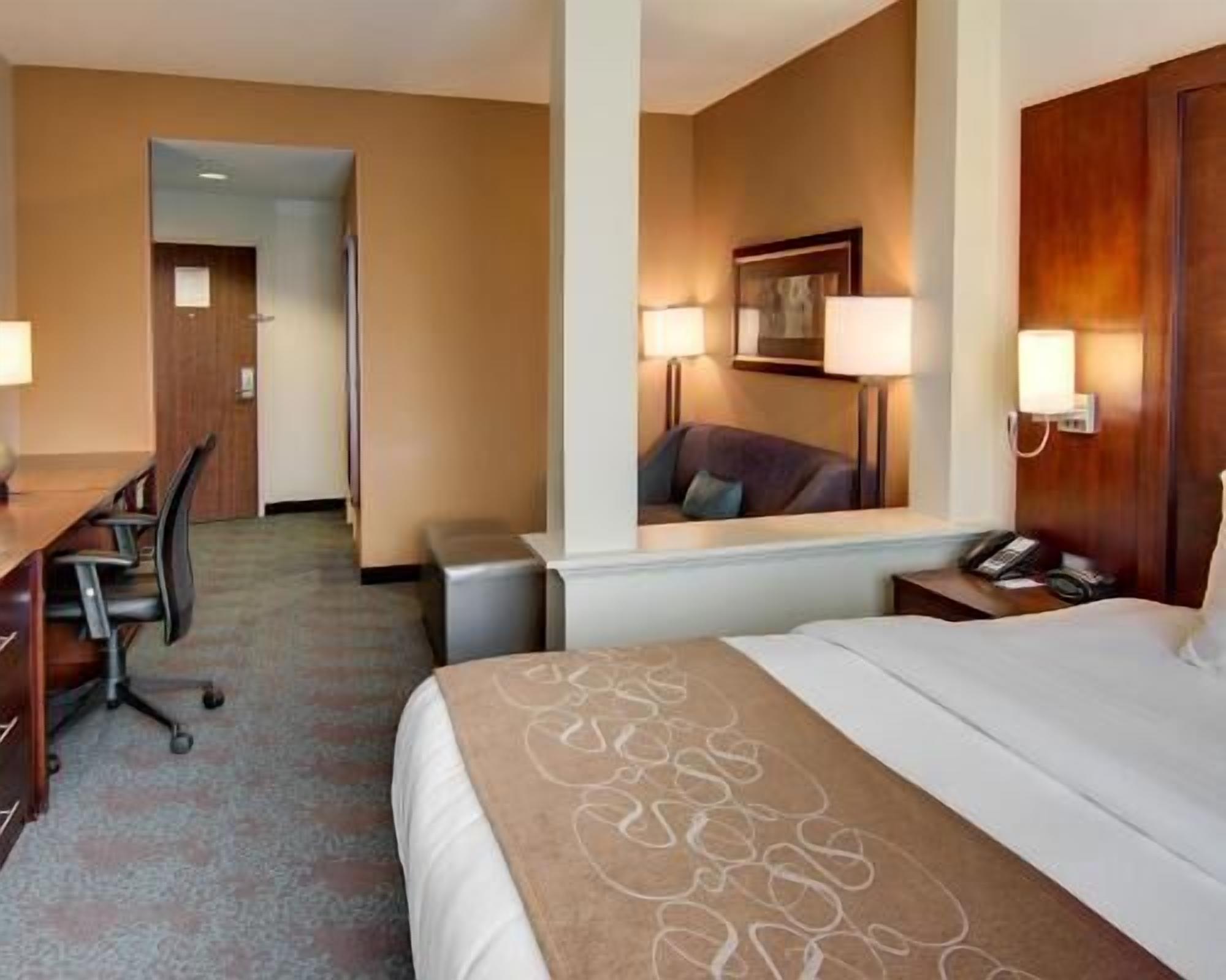 Premium bedding, desk, laptop workspace, blackout drapes