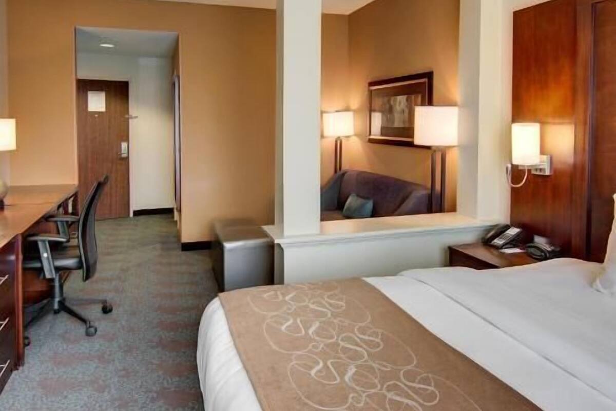 Premium bedding, desk, laptop workspace, blackout drapes