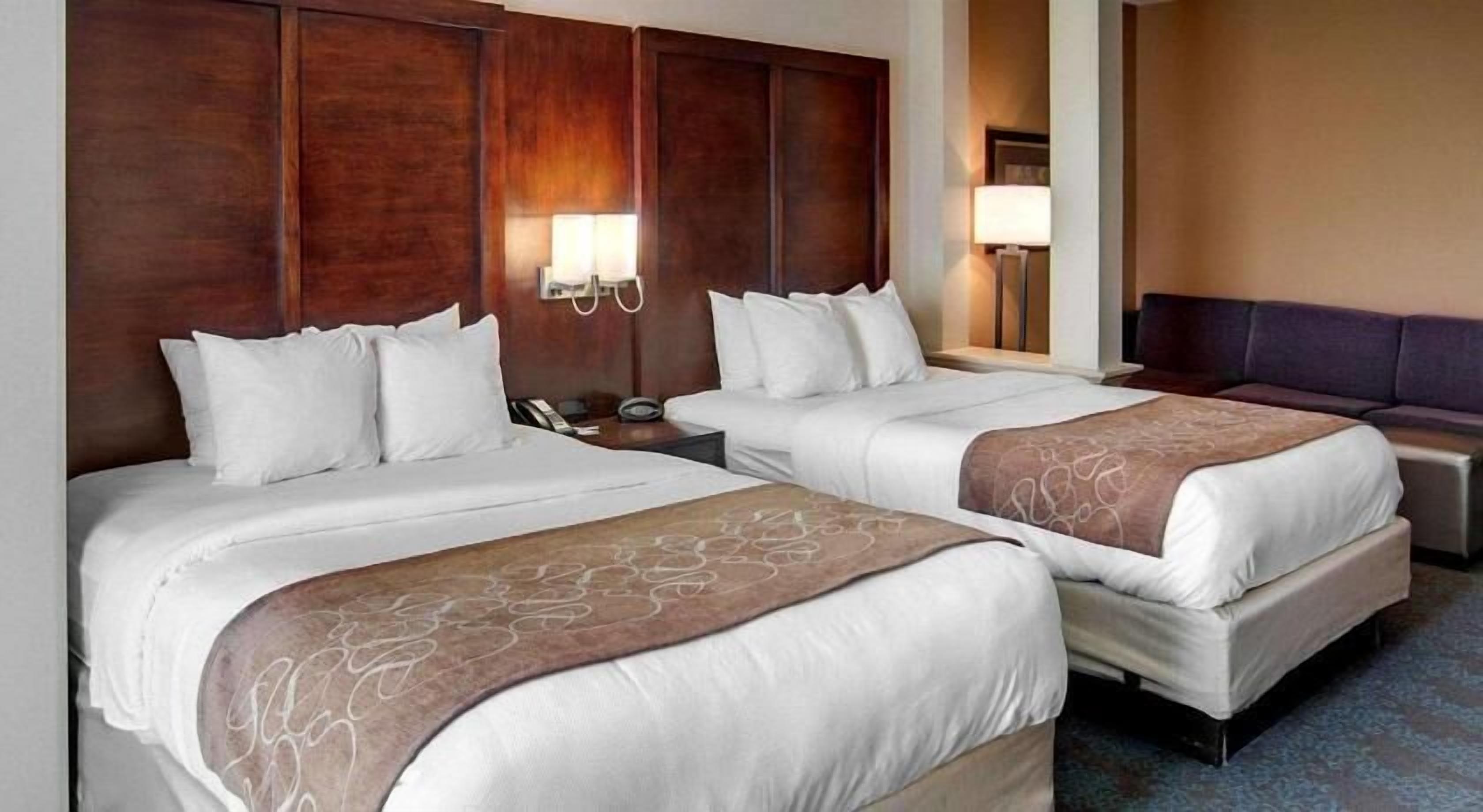 Premium bedding, desk, laptop workspace, blackout drapes