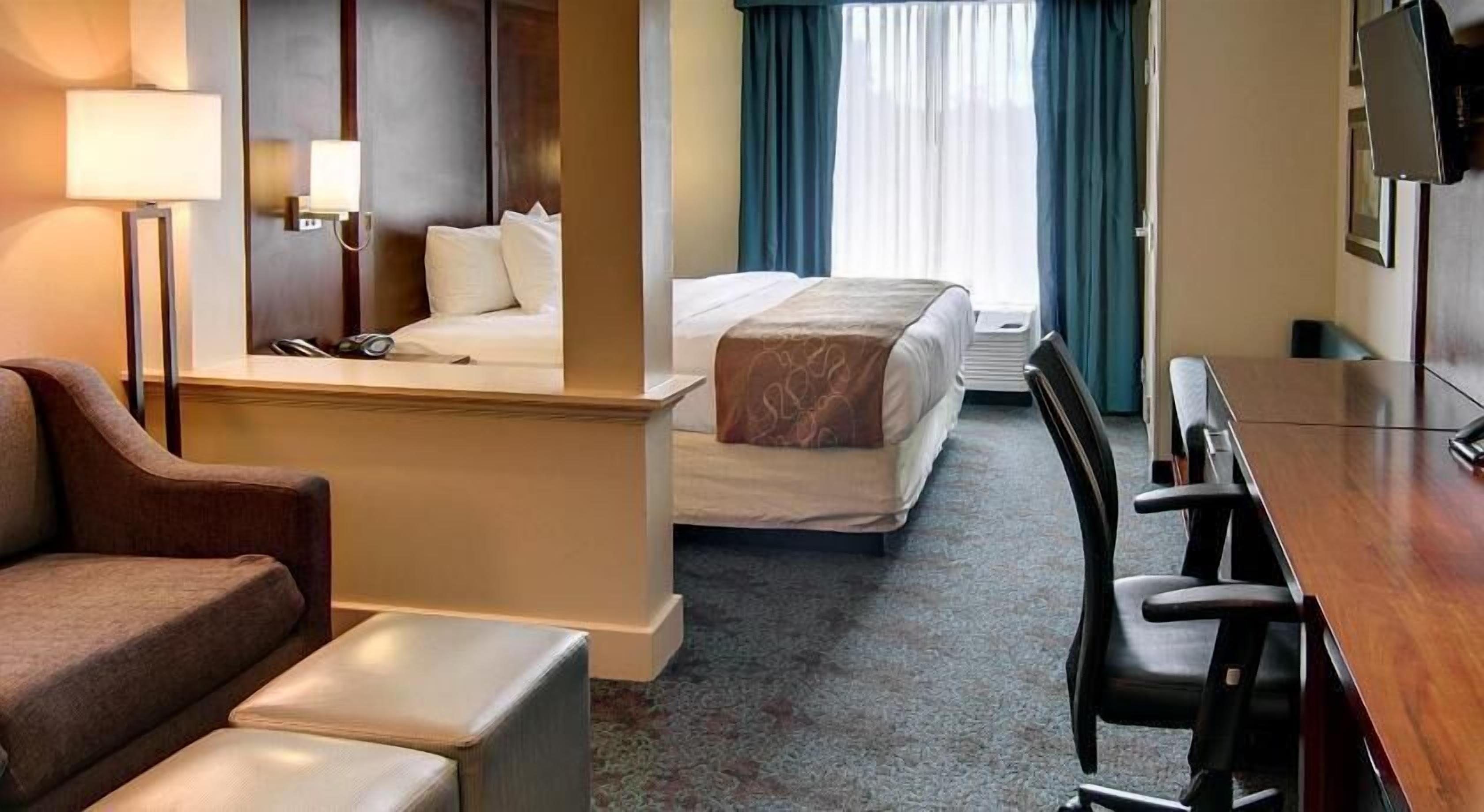 Premium bedding, desk, laptop workspace, blackout drapes