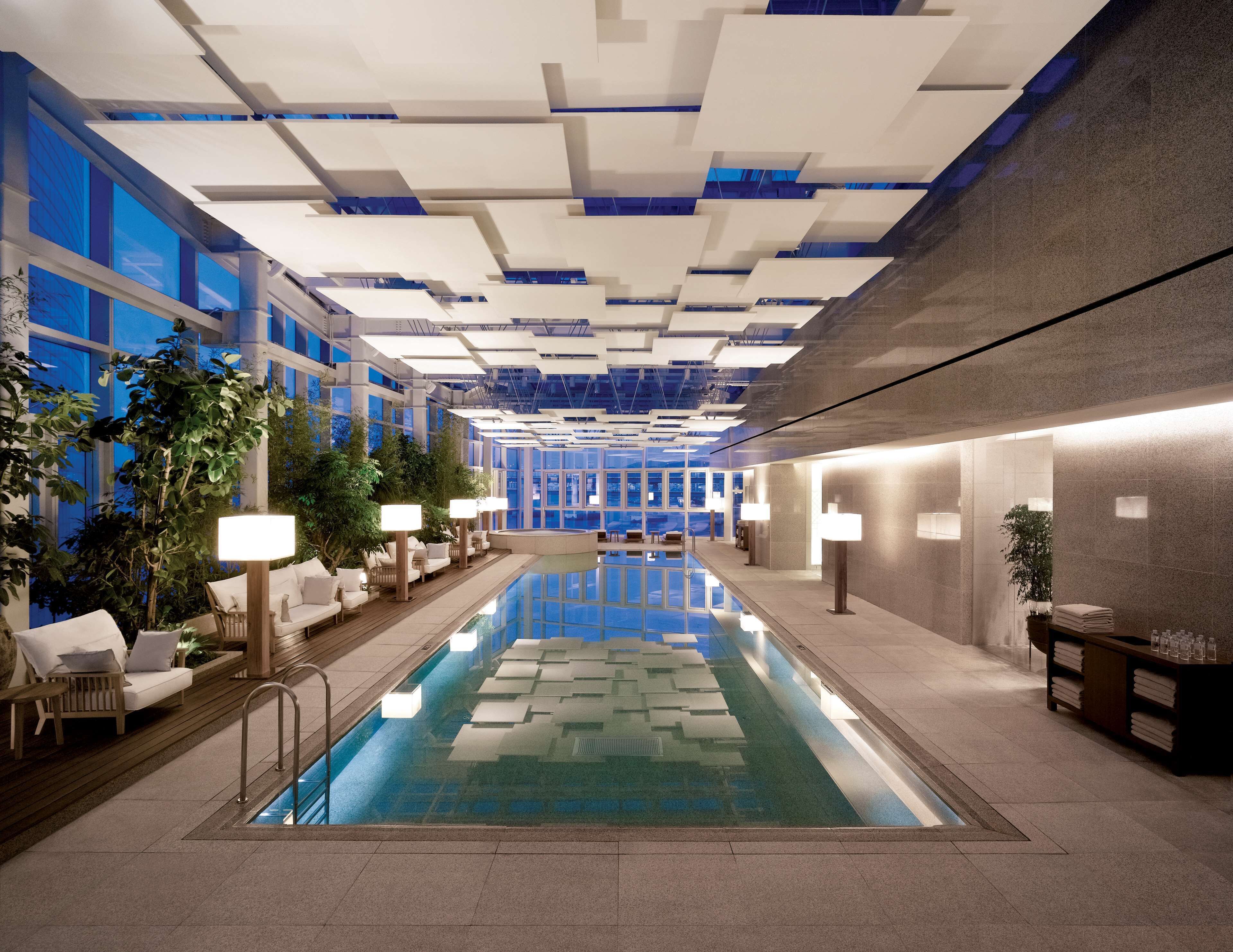 Una piscina techada, sillones reclinables de piscina