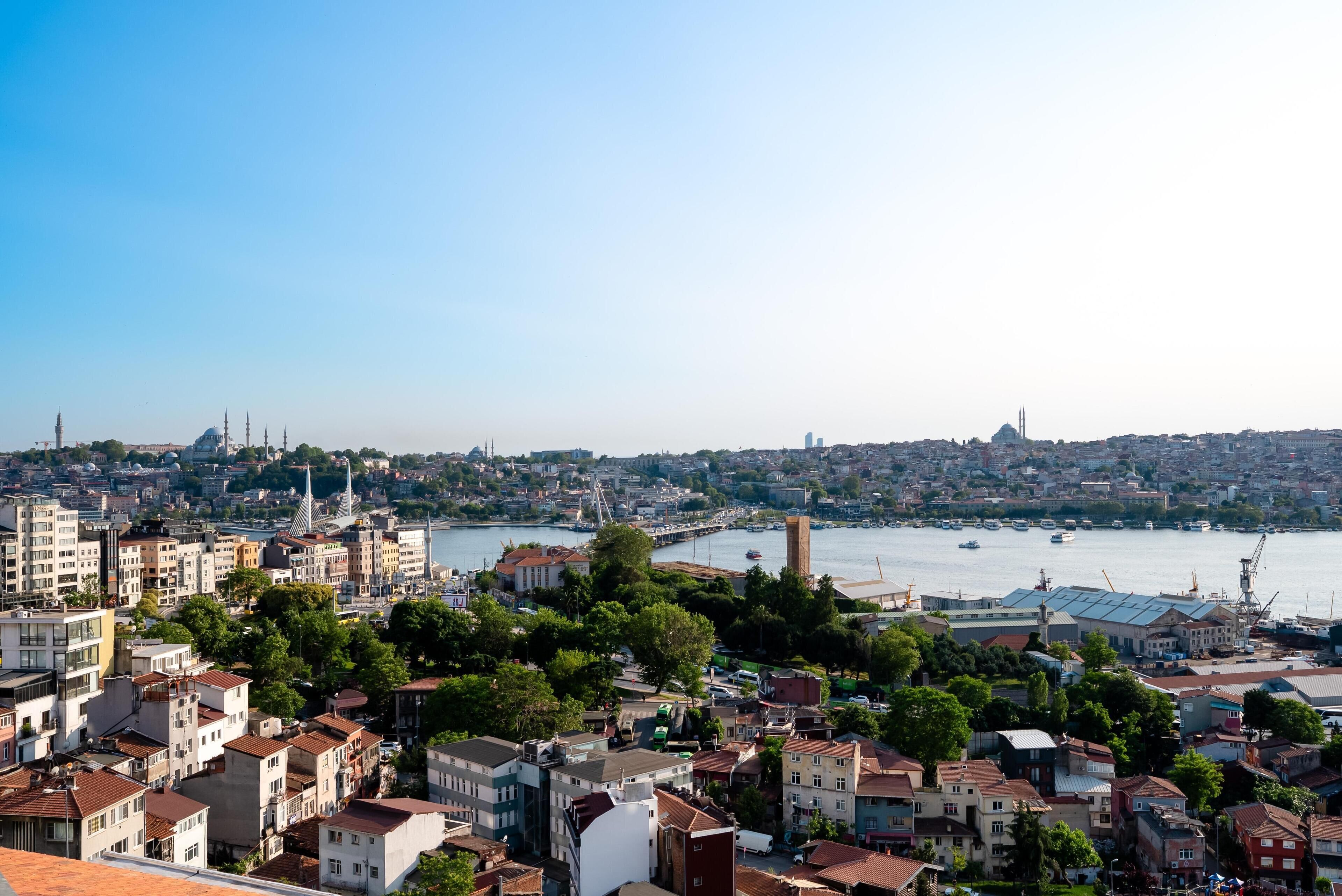 A cityscape with a river, buildings, and a bridge.