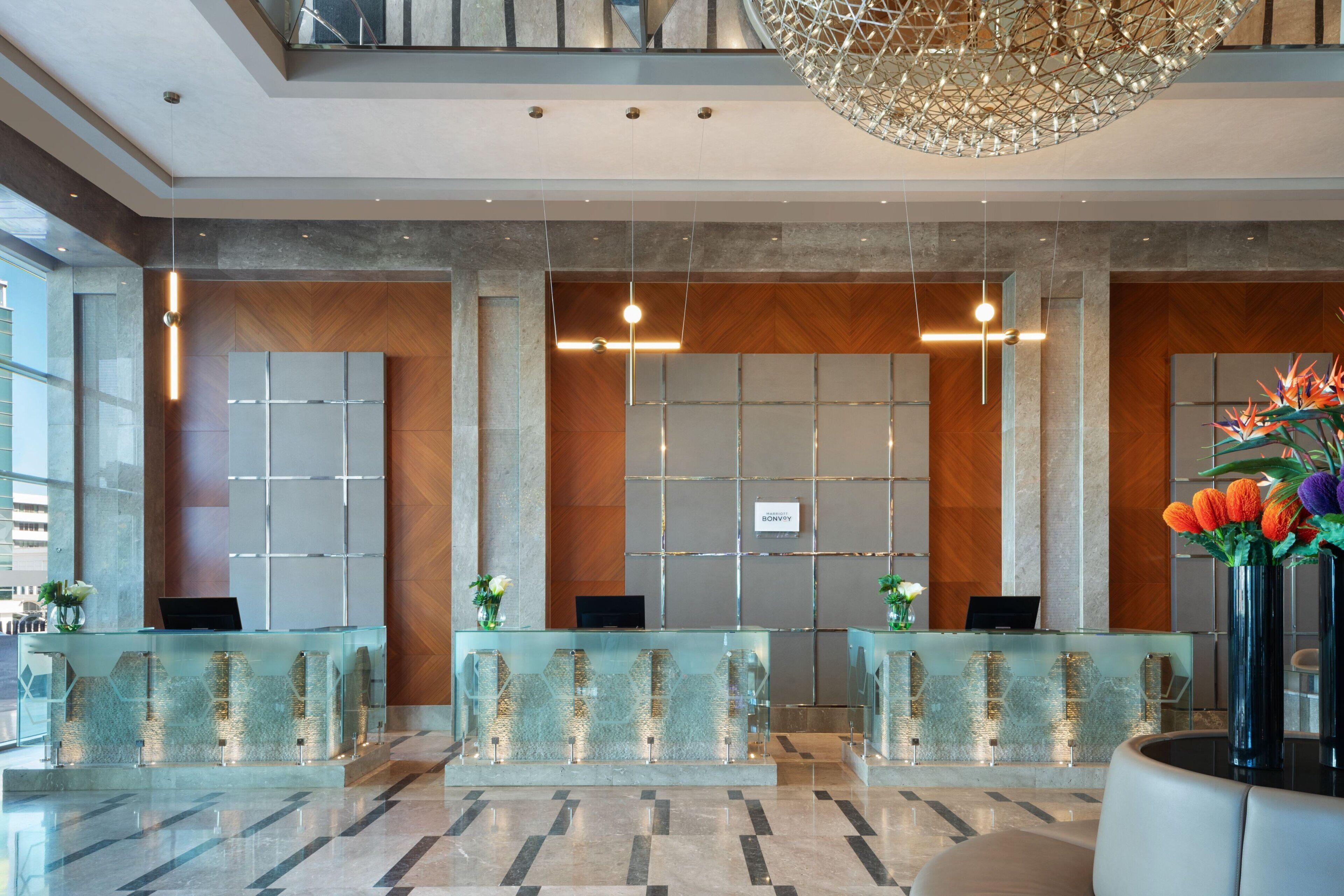 A reception area with glass counters, a modern chandelier, and a 'BONVIVI' sign.