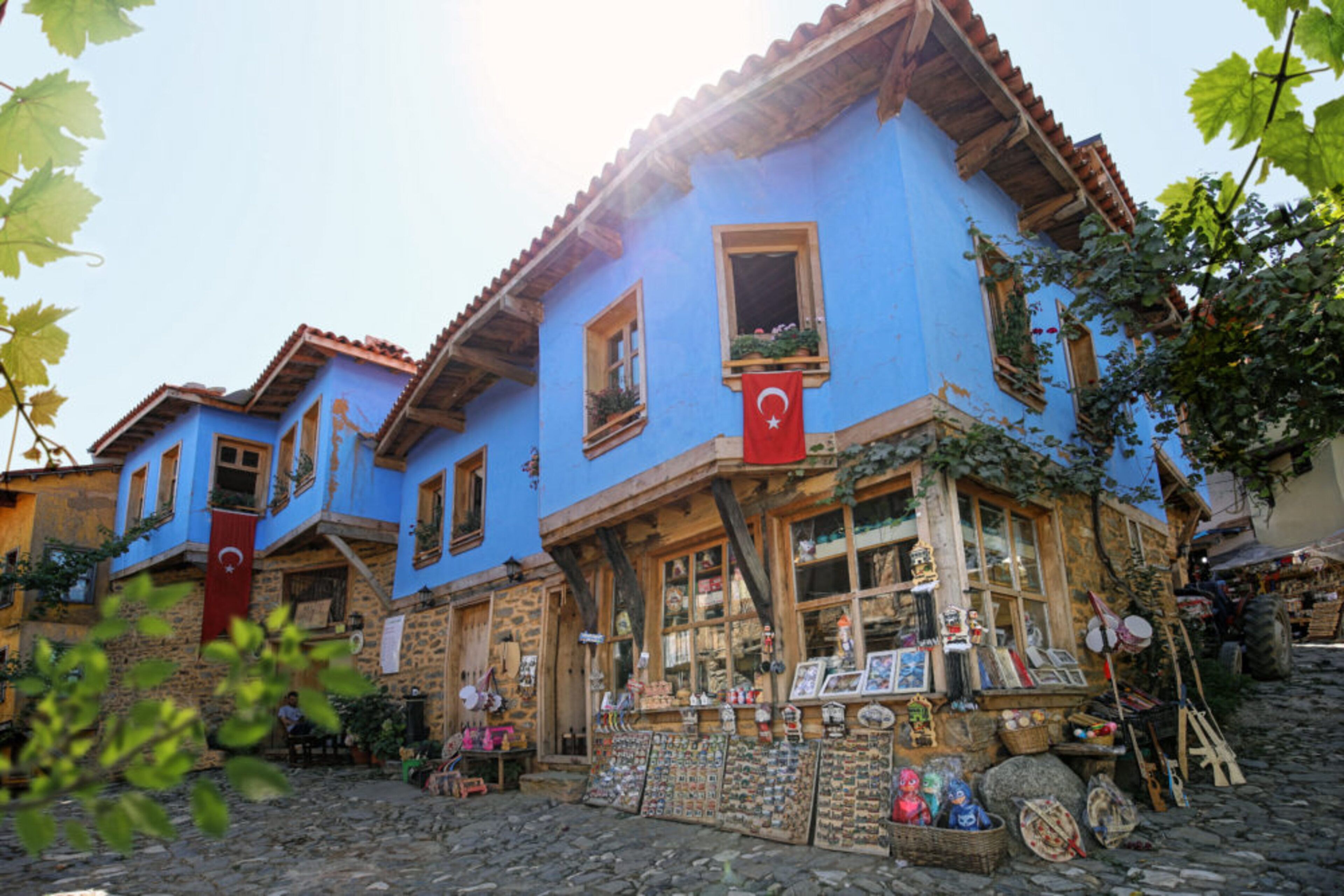A traditional blue building with a shop on the ground floor.