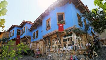 A traditional blue building with a shop on the ground floor.