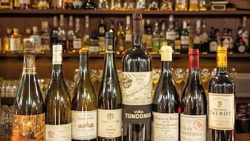 A selection of wine bottles on a bar counter with a variety of labels and designs.