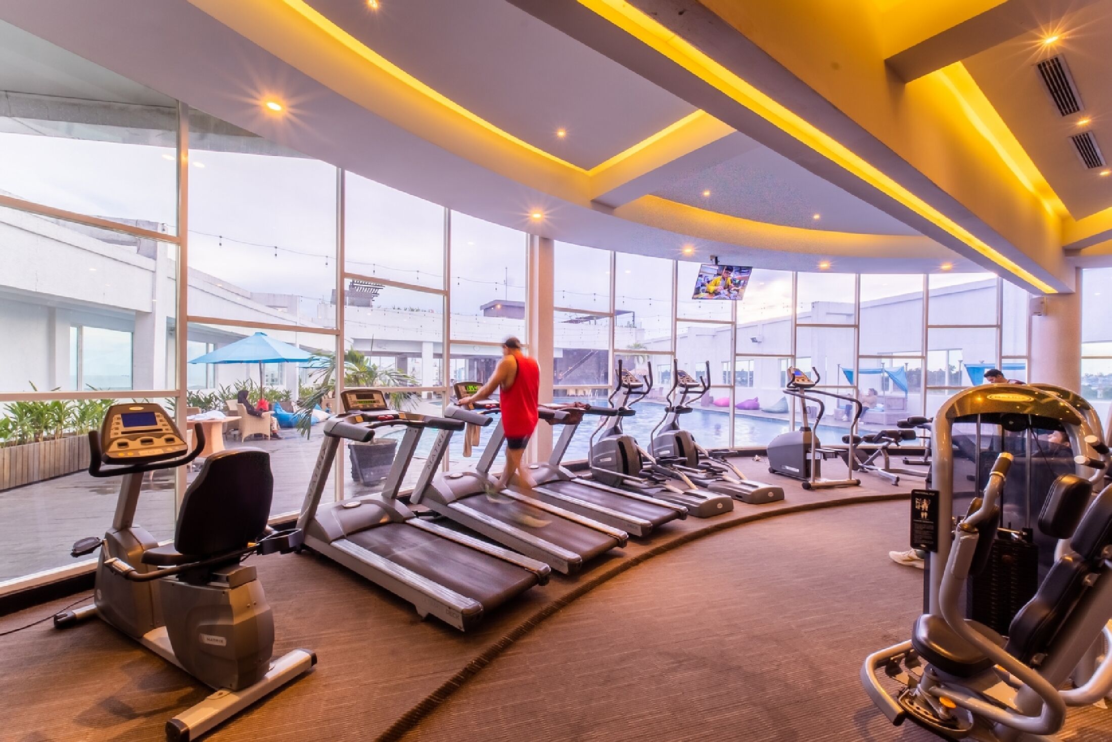 A gym with treadmills, elliptical machines, and weight equipment.