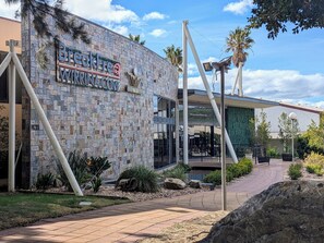 A modern building with a stone facade and a sign that reads "BreckFree WIRING COVE NEW TERRY". - BreakFree Wirrina Cove (Wirrina Cove)