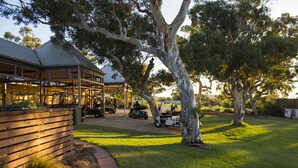 A building with a covered patio area, surrounded by trees and a grassy lawn. - BreakFree Wirrina Cove (Wirrina Cove)