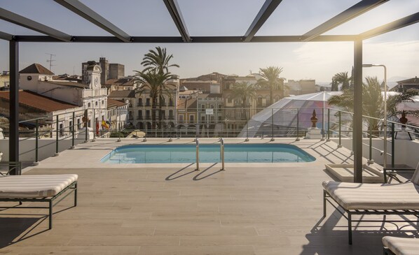 Seasonal outdoor pool, pool loungers