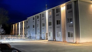 A multi-story building with a flat roof, large windows, and a gated entrance. - River Canyon Lodge (Moab)