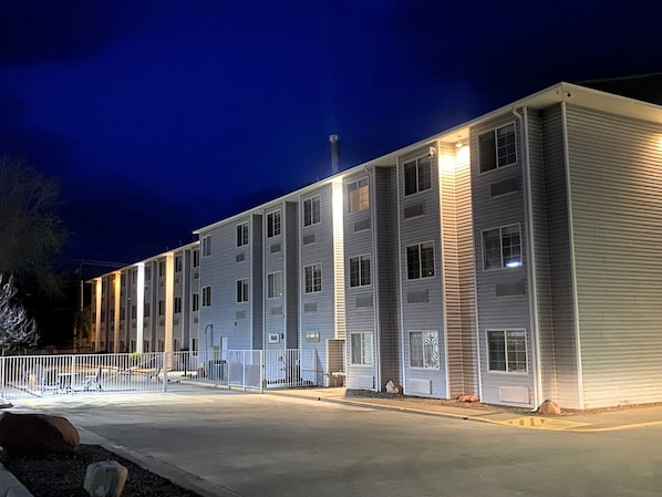 A multi-story building with a flat roof, large windows, and a gated entrance. - River Canyon Lodge (Moab)