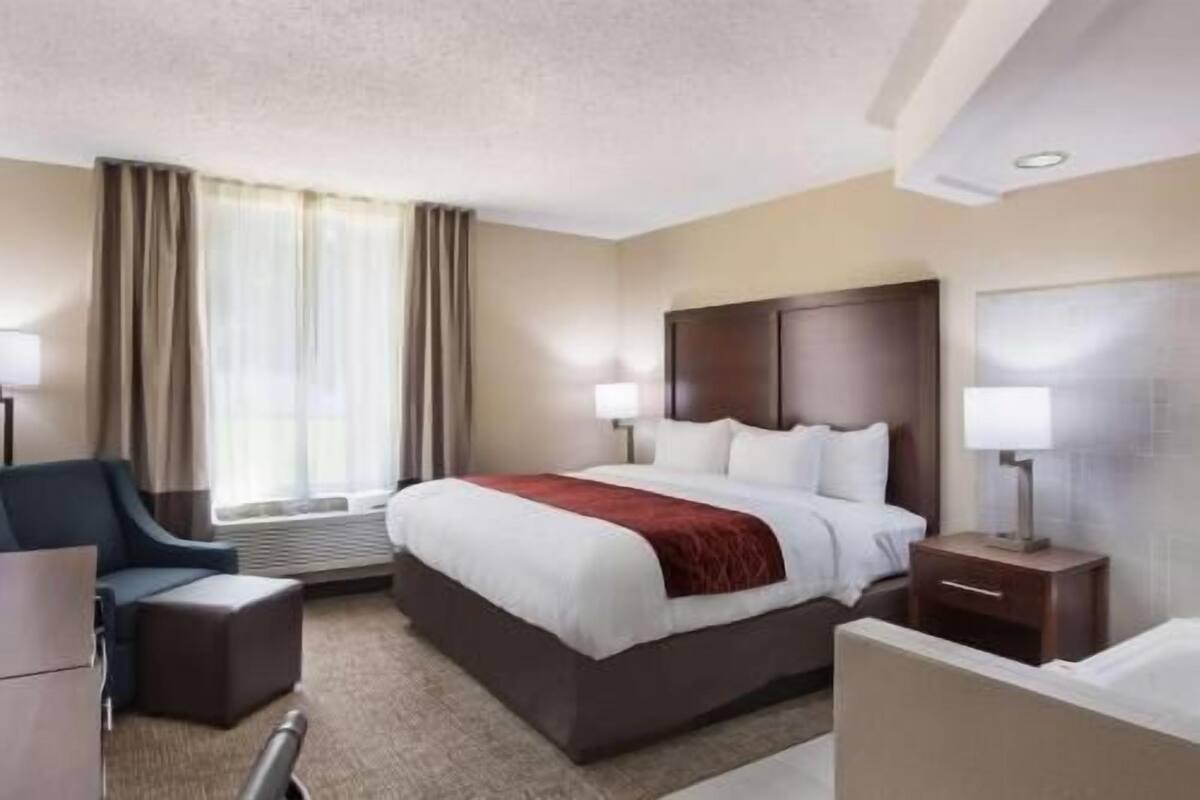 Desk, laptop workspace, blackout drapes, iron/ironing board