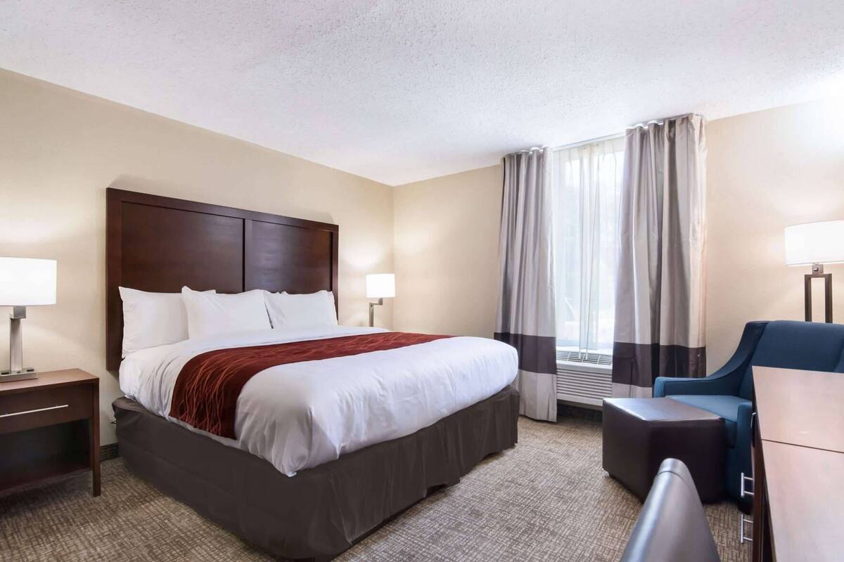 Desk, laptop workspace, blackout drapes, iron/ironing board