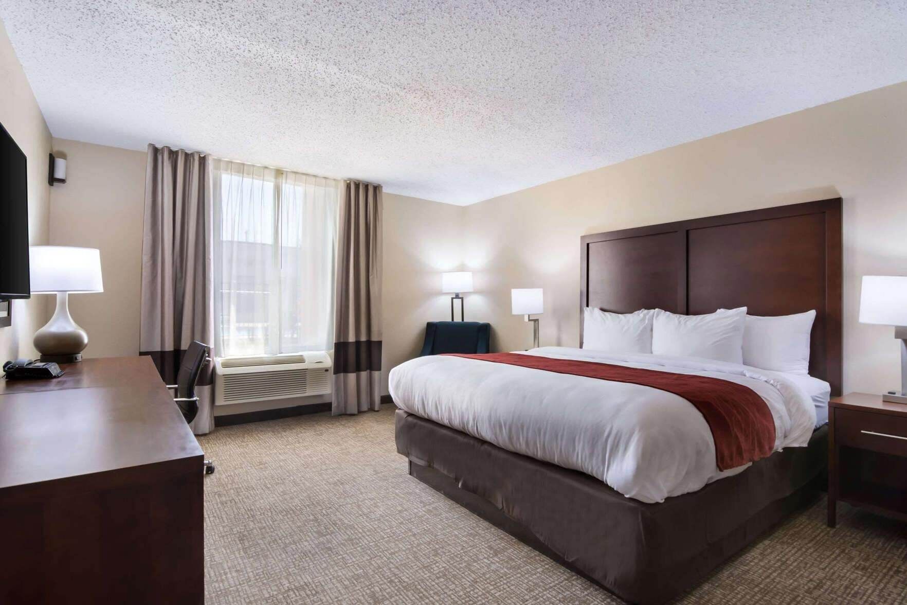 Desk, laptop workspace, blackout drapes, iron/ironing board