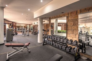 A gym with various exercise equipment, including treadmills, weight machines, and dumbbells. - Fort Arabesque Resort, Spa & Villas (Makadi Bay)