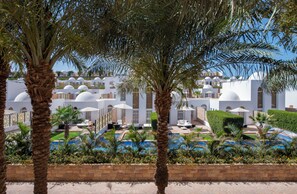 A resort with multiple white domed buildings, a swimming pool area, and palm trees. - Fort Arabesque Resort, Spa & Villas (Makadi Bay)