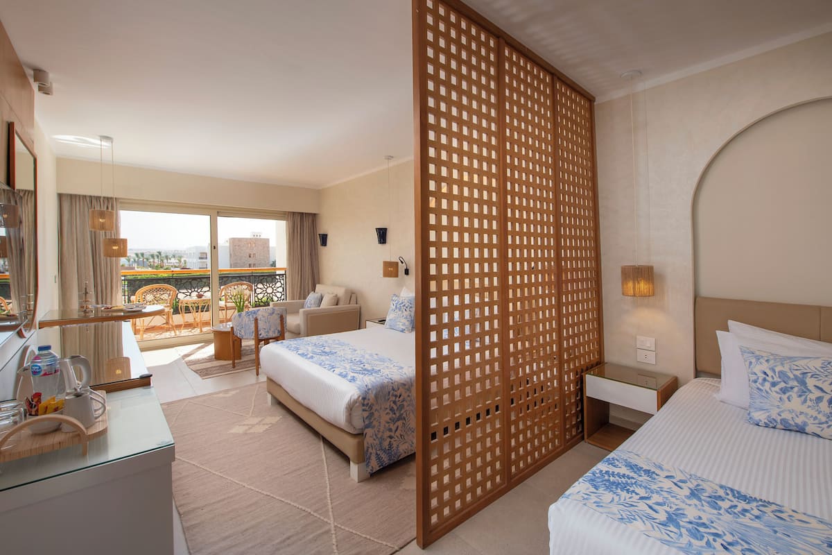 Deluxe Room, Partial Sea View | Minibar (some free items), in-room safe, desk, blackout drapes
