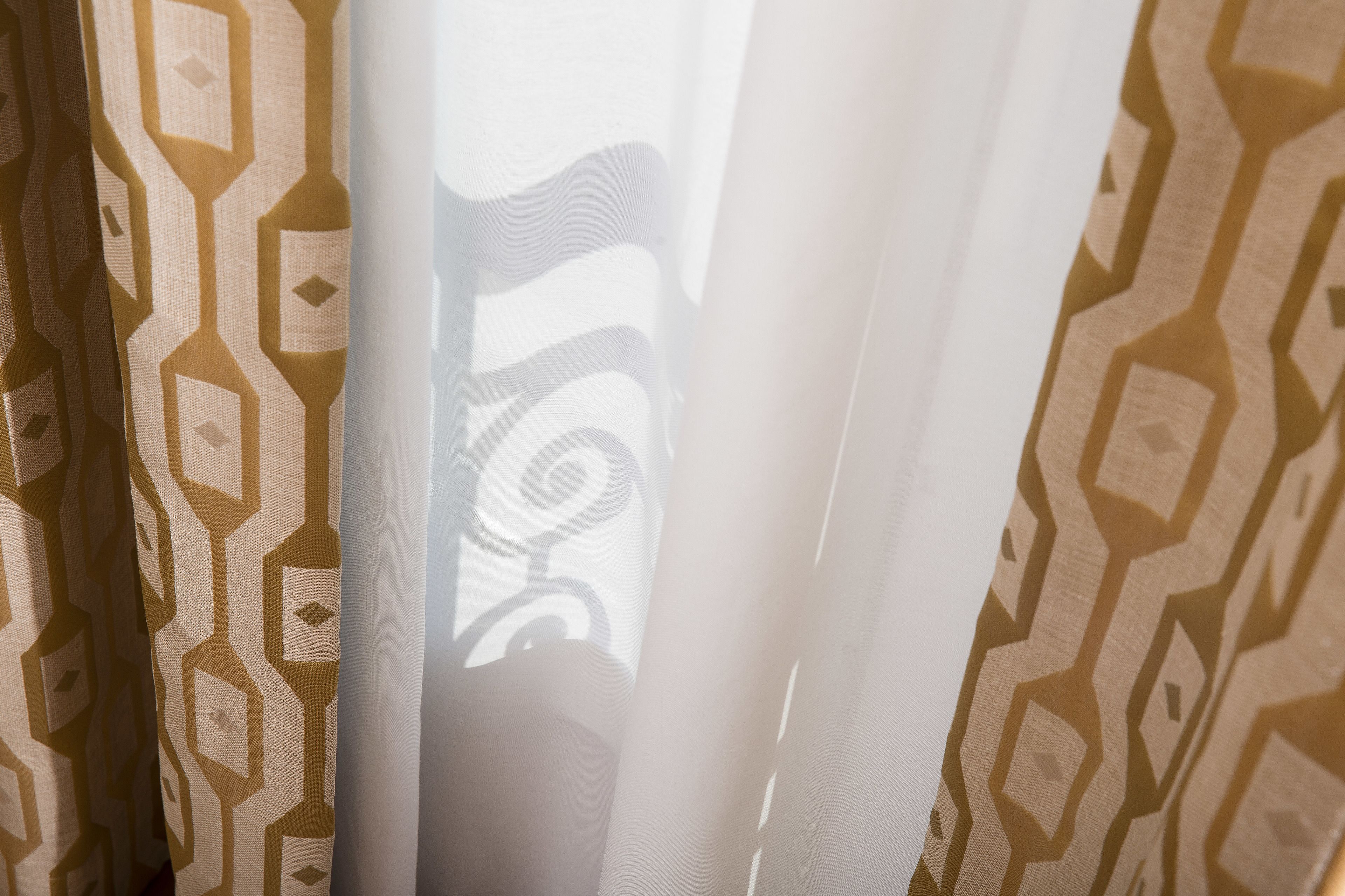 A patterned curtain with a geometric design.