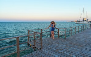 On the beach, white sand, sun loungers, beach umbrellas