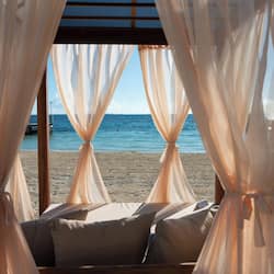 On the beach, white sand, sun loungers, beach umbrellas