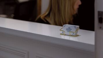 A reception desk with a mirror and a sign that reads "BOYSWATER BOUTIQUE".