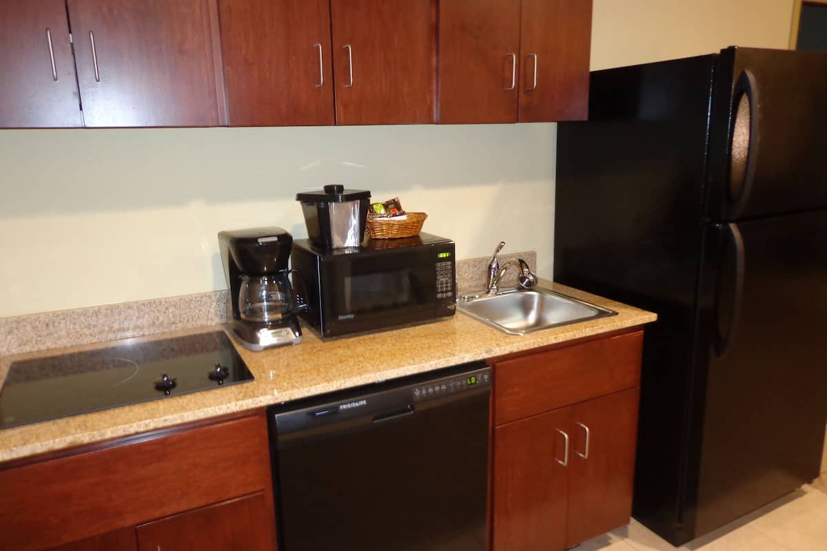 suite, 1 king bed with sleeper sofa, accessible benched tub, non smoking | private kitchenette | fridge, coffee/tea maker