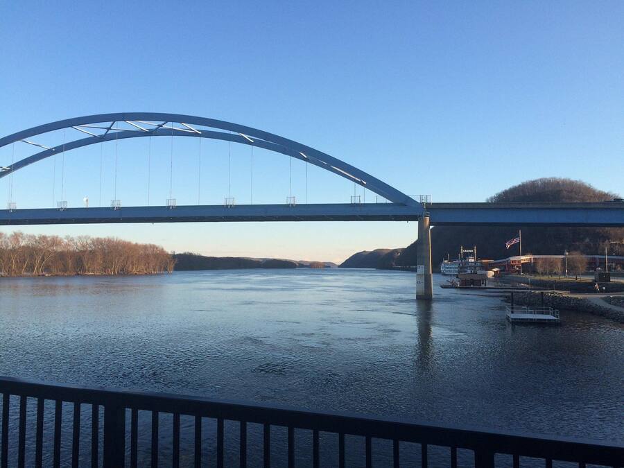 A large bridge spanning a river with a clear sky.