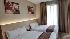 A hotel room with two beds, beige walls, and two abstract paintings. - DeHome Boutique Hotel (Kuching)