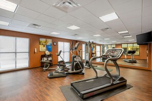 A gym with treadmills, elliptical machines, and a mirrored wall. - Comfort Inn & Suites Sayre (Sayre)