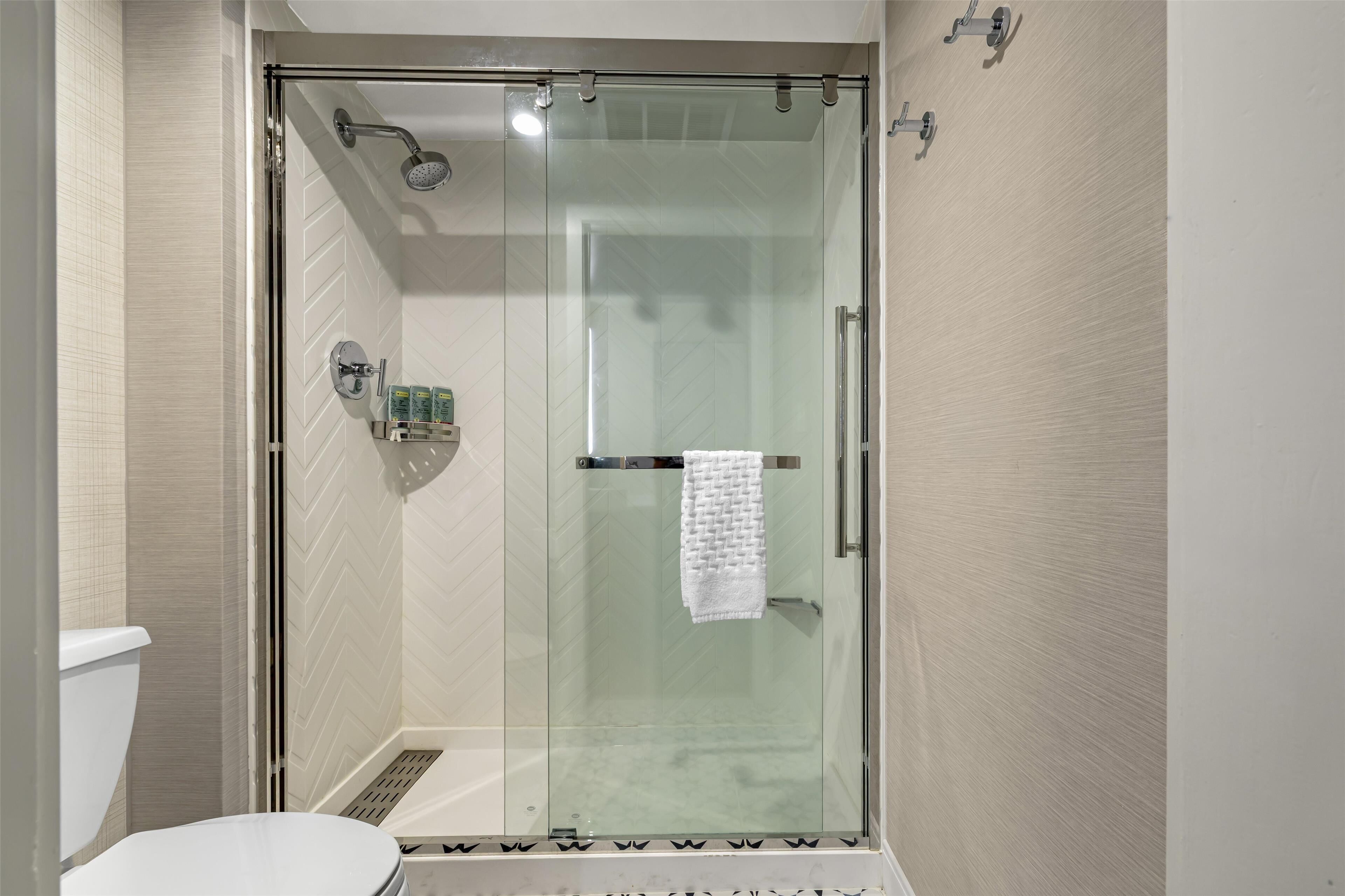 combined shower/bathtub, rainfall showerhead, designer toiletries