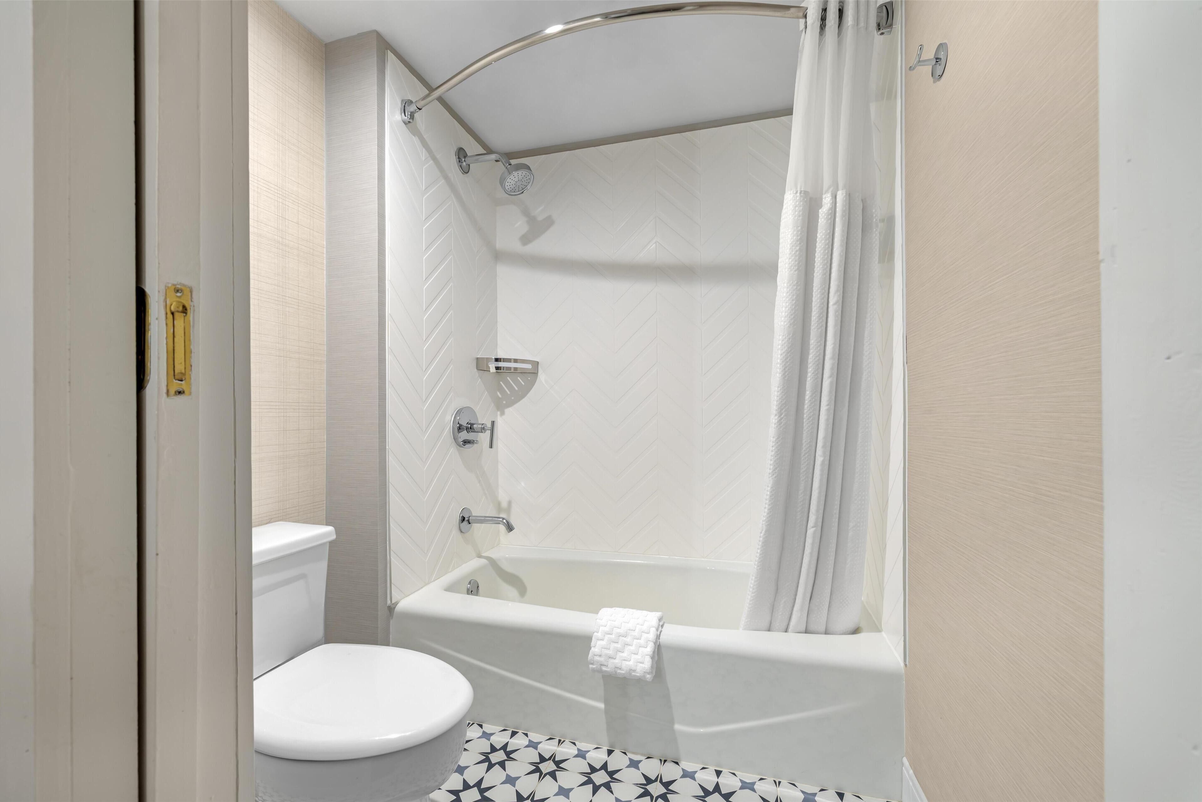 combined shower/bathtub, rainfall showerhead, designer toiletries