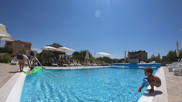 Seasonal outdoor pool, a waterfall pool, pool umbrellas, pool loungers