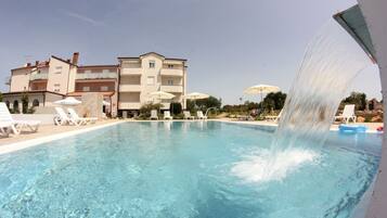 Seasonal outdoor pool, a waterfall pool, pool umbrellas, pool loungers