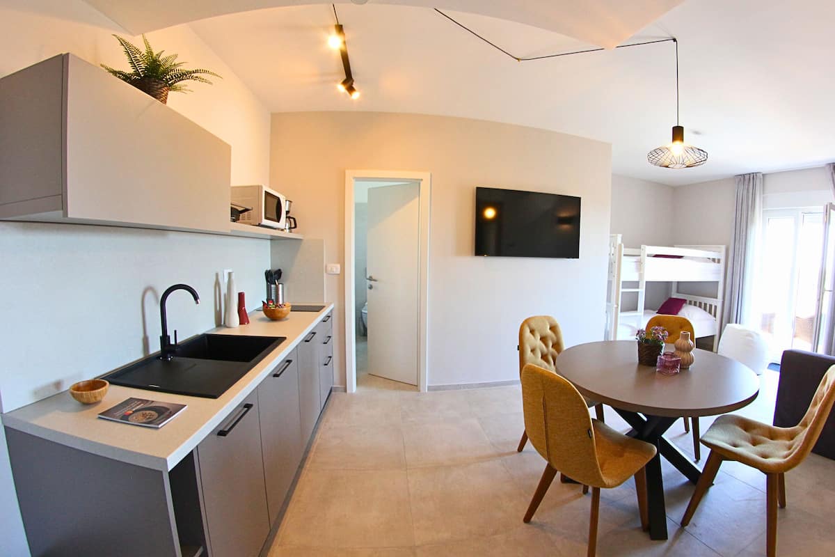 Family Room, Kitchenette | In-room safe, desk, free WiFi, bed sheets