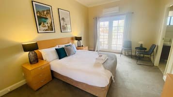 Modern Queen Room | 1 bedroom, individually decorated, individually furnished, bed sheets