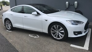 A white Tesla Model S parked in a charging station. - ibis Styles Vannes Porte du Golfe (Vannes)